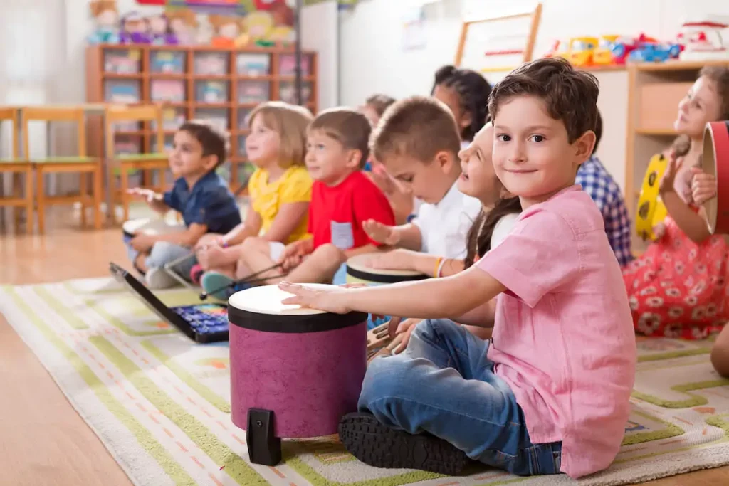 Preschool kids playing drums and percussions