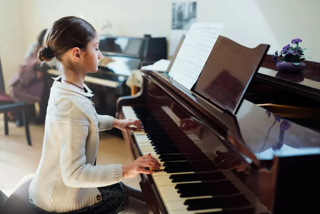 a girl learning to play the piano